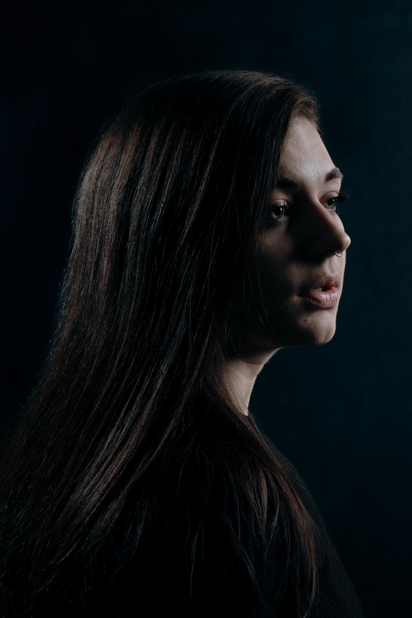 Cinematic low-key portrait, dramatic directional light